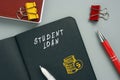 Business concept about STUDENT LOAN with phrase on the page. StudentÃÂ debt are funds that are owed on aÃÂ loanÃÂ taken out to pay